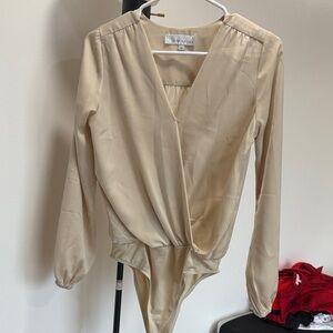 Adelyn Rae Cream Long Sleeve Bodysuit